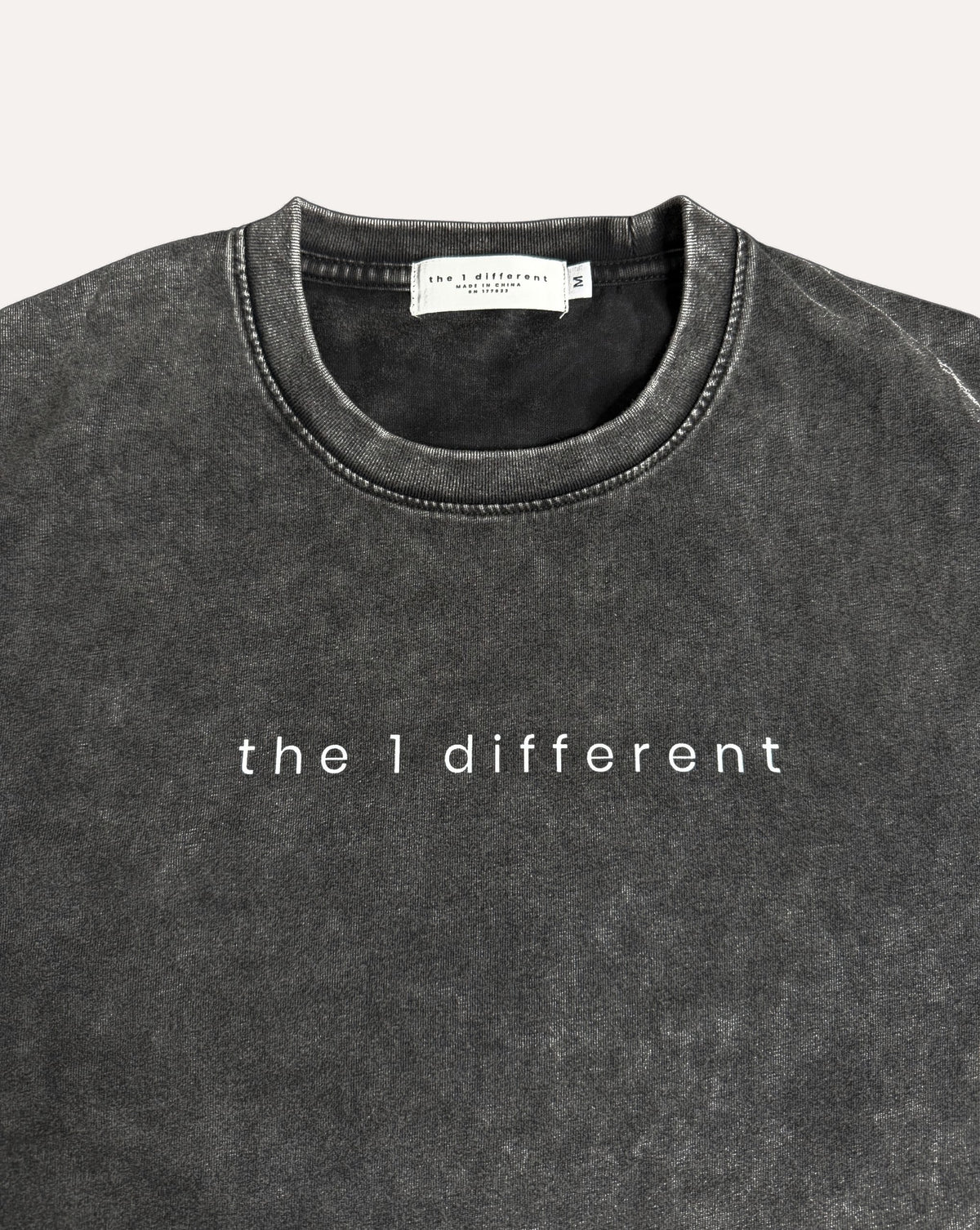 Black the1different snow-wash tee, collar label and chest print close-up