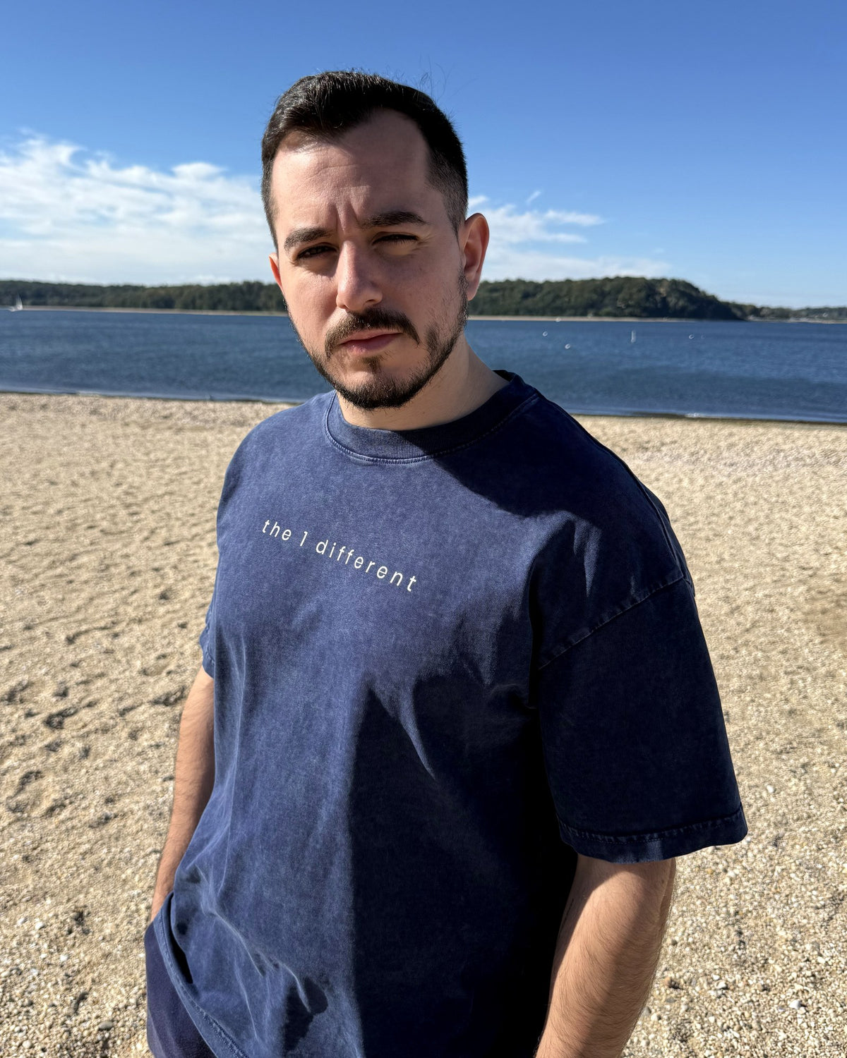 Martin, founder of the1different, wearing the Royal Blue tee at the beach